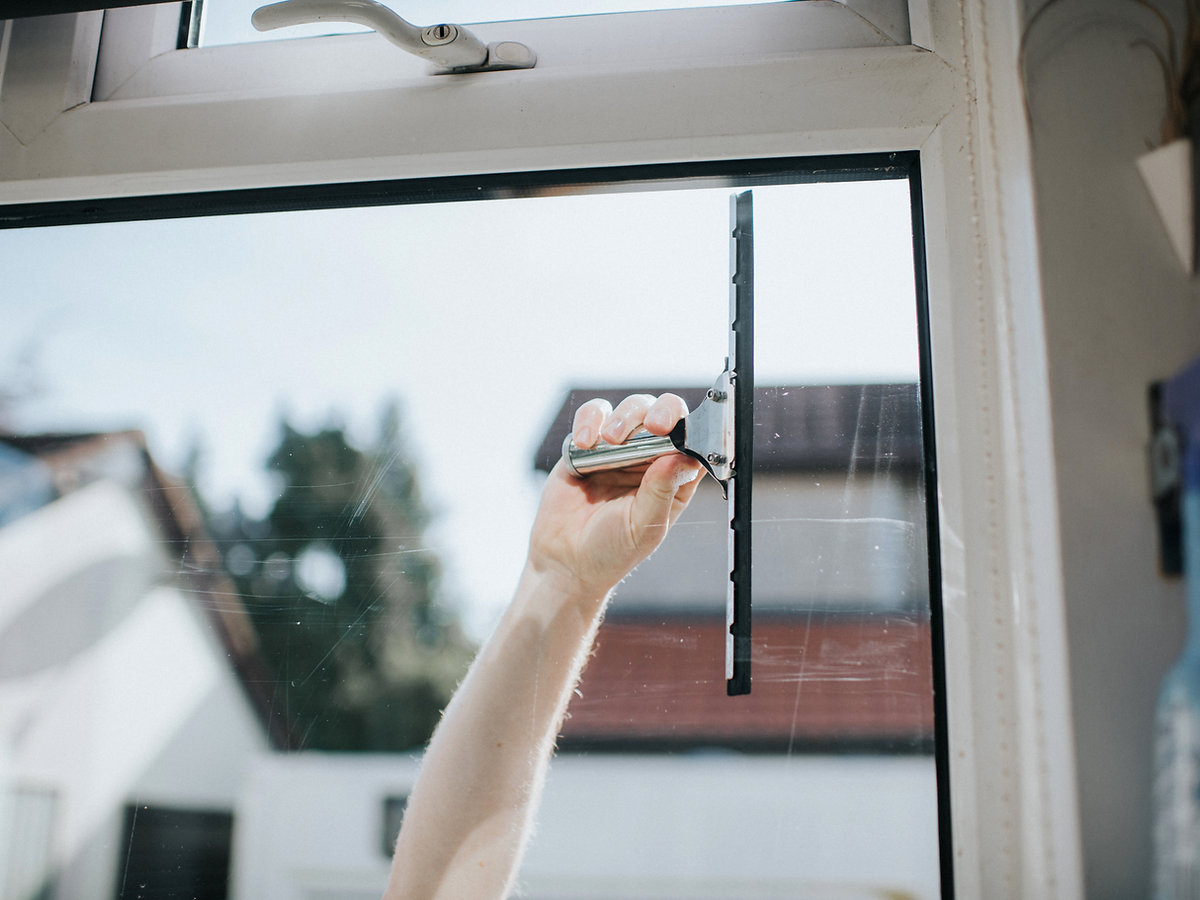 Window cleaning with a squeegee on exterior glass